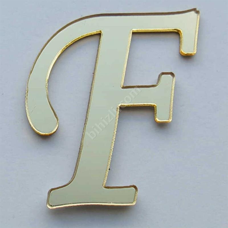 F harfi (altın renk)